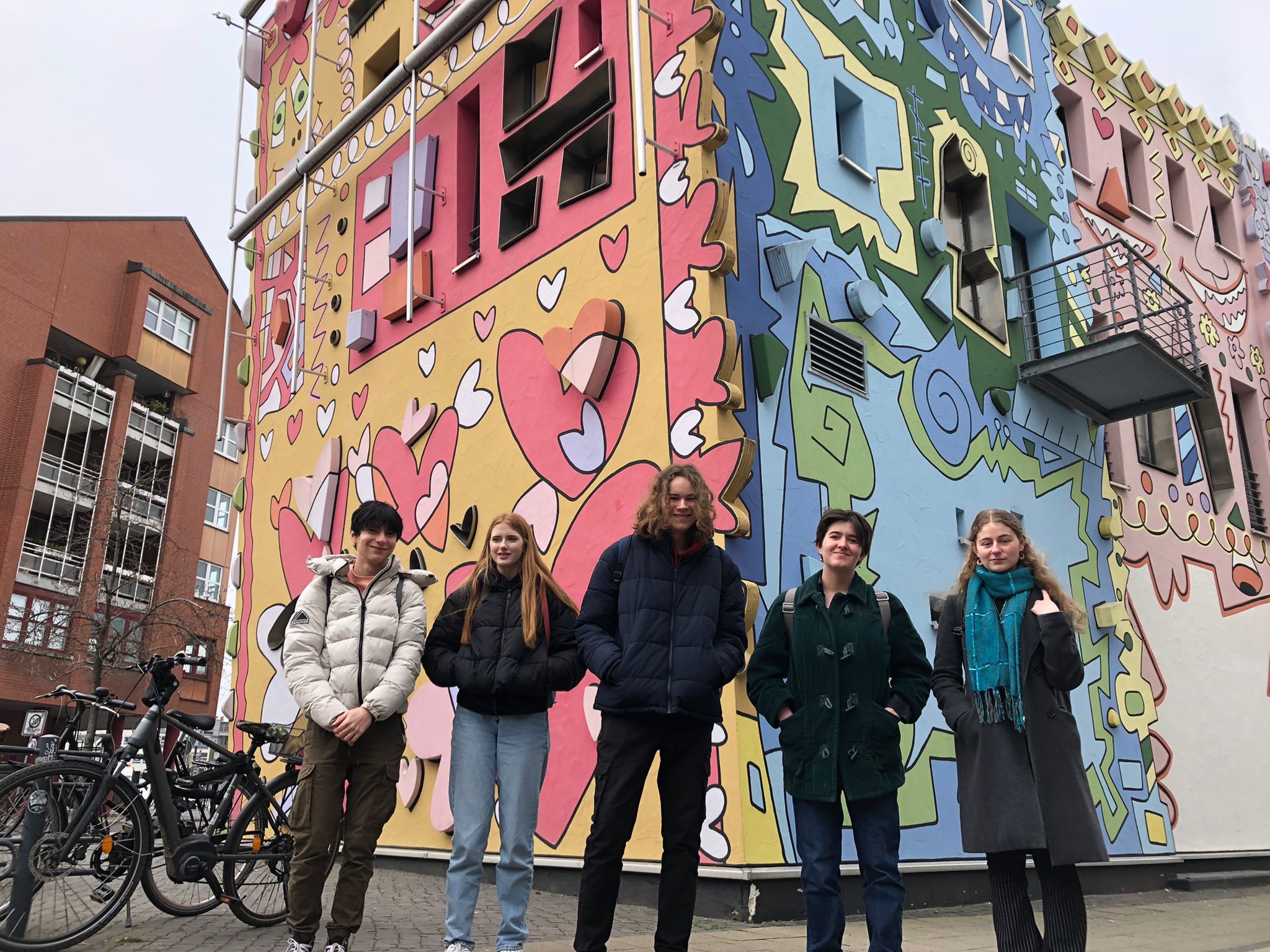 Students stand outside the colourful Rizzihaus in Brunswick