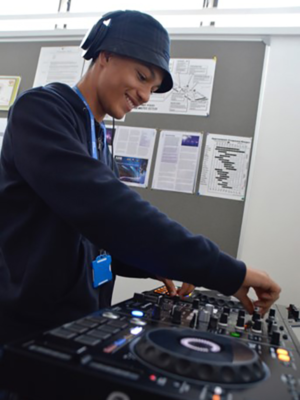 Music Technology student using a mixing deck