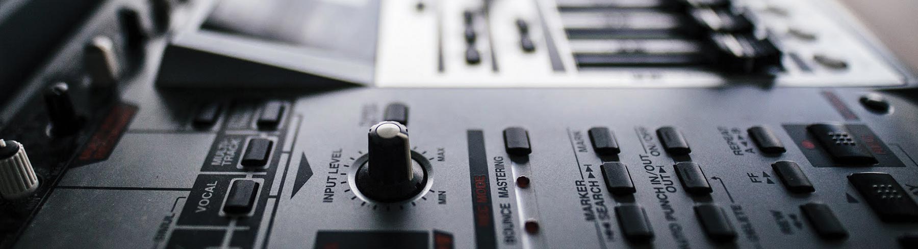 A closeup of the dials on a mixing deck