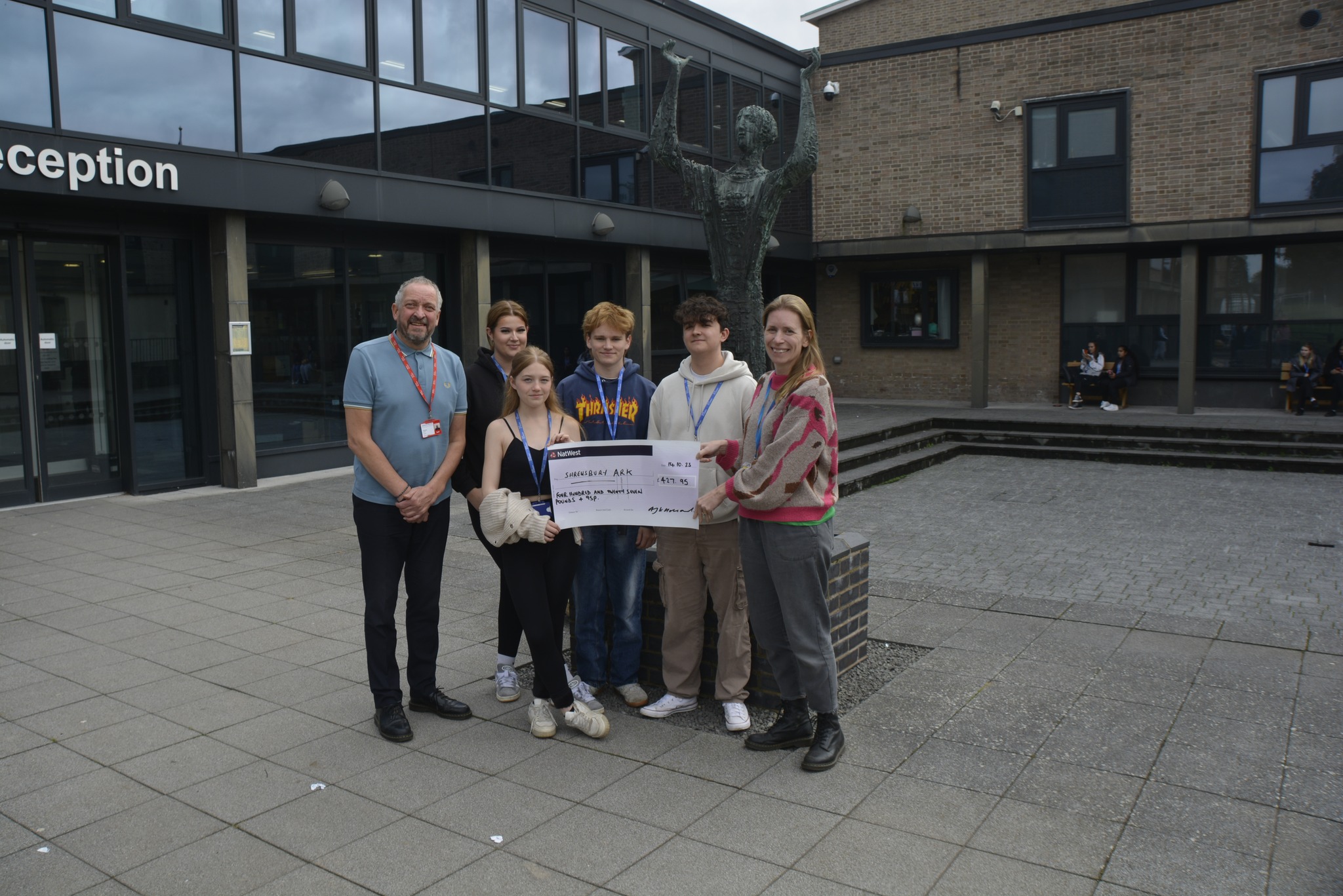 Business Students pose with cheque