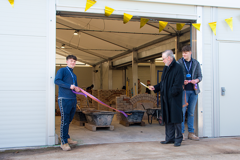 Iain Gilmour, Chair of the Radbrook Foundation, opening the Brick Workshop alongside apprentices Finnbar and Joel