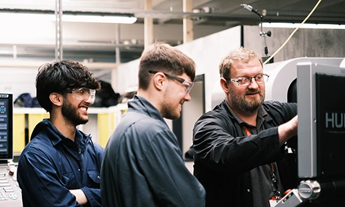 Engineering Tutor demonstrating machine to students