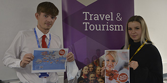 Travel & Tourism students holding up pages from their Jet2 welcome pack