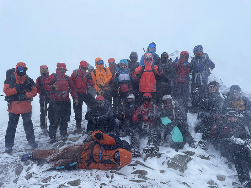 Outdoor Activities students on a mountaintop in the snow