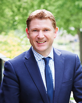 Head and shoulders photo of Principal, James Staniforth wearing a suit and tie