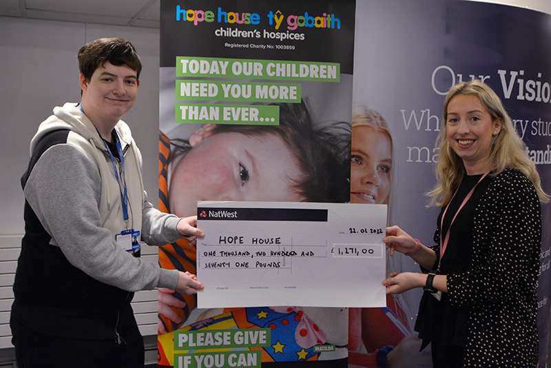 Dan Gough (student) present Bekki from Hope House with a cheque