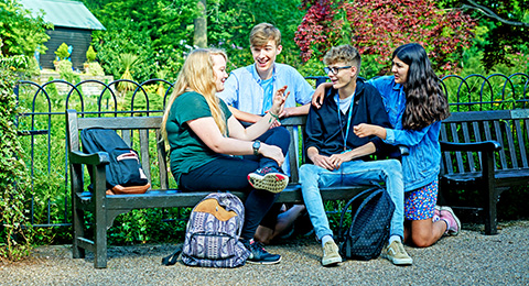 SCG students sitting on bench in college grounds