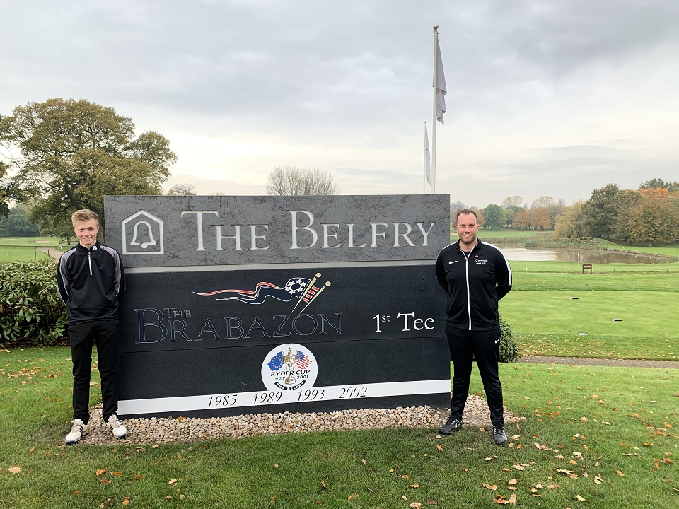 Sports student and sports teacher standing in front of sign for The Belfry