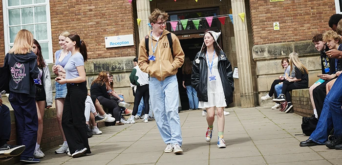Two students walking out of college