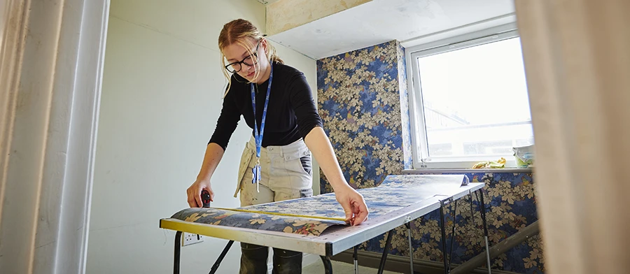 Student cutting and matching wallpaper