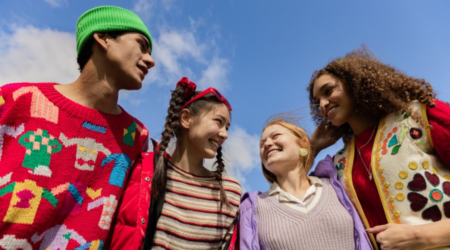 Four students under blue sky