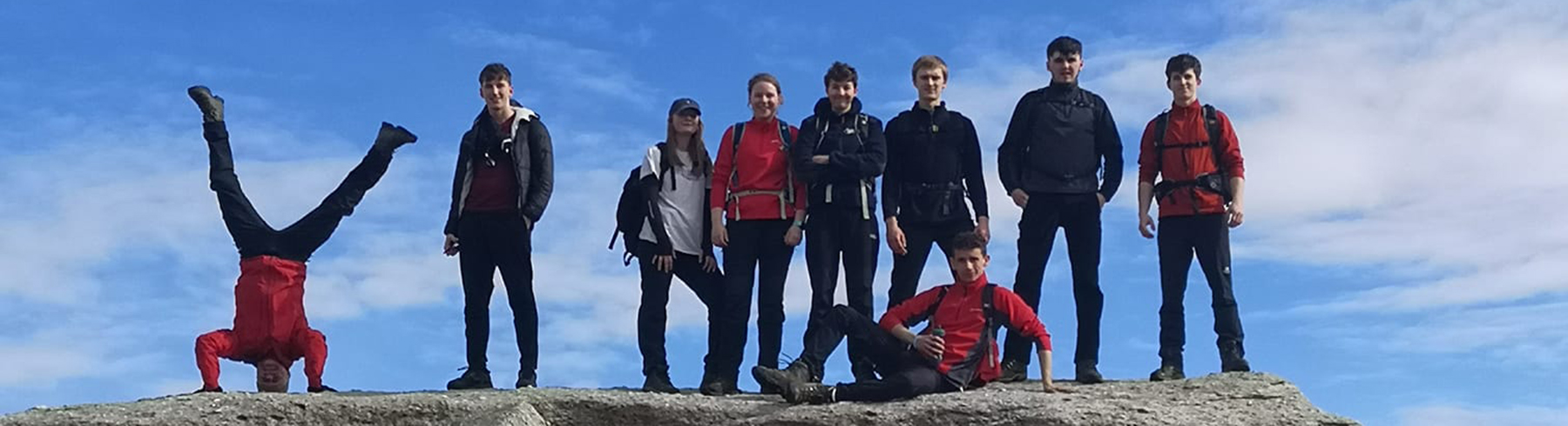 Group of students on top of rock formation