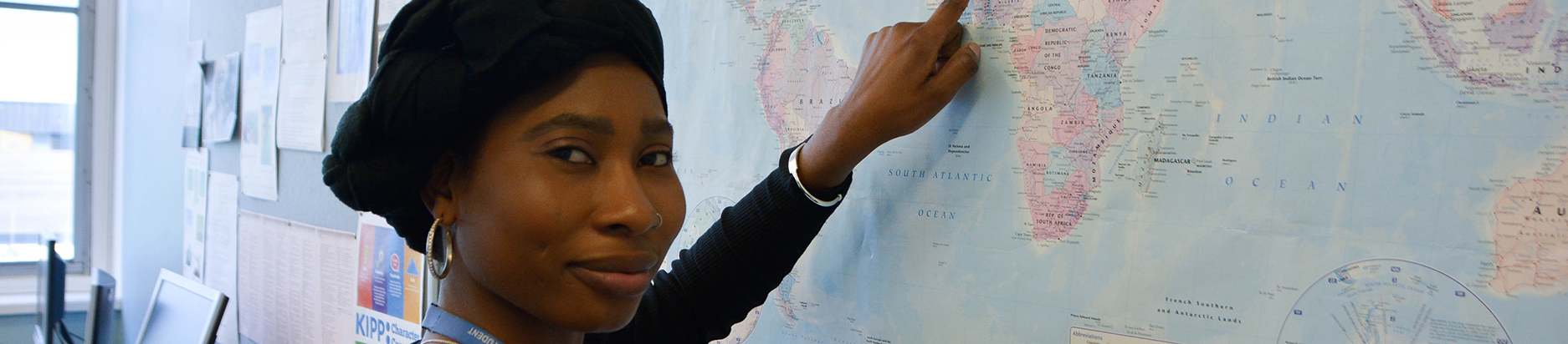 A student pointing to Africa on a large map 